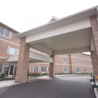 A residential building with a covered driveway entrance.