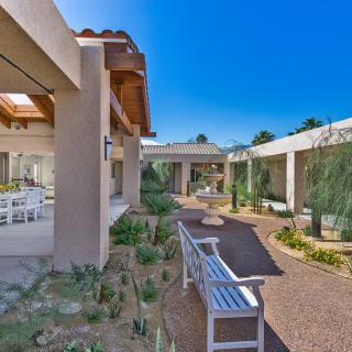 A modern outdoor space with pathways, benches, and contemporary architecture.