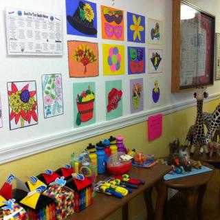 A colorful classroom wall showcasing children's artwork and crafts.