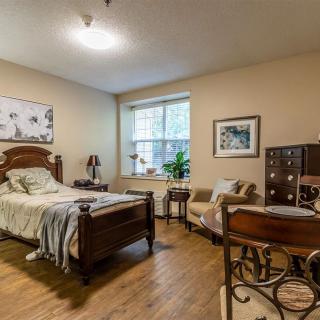 A cozy bedroom with a wooden bed and tasteful decor.