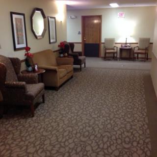 A hallway with seating arrangements and decorative elements.