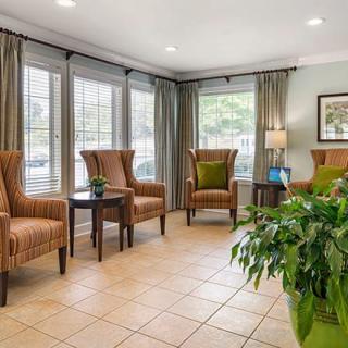 A comfortable waiting room with armchairs and natural lighting.