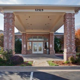A building entrance with brick columns and an address number displayed above.