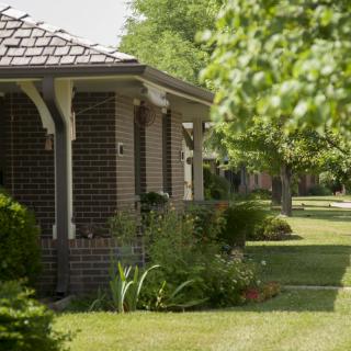 A suburban house with a well-maintained garden and lush greenery.
