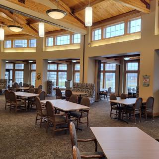 A spacious library interior with wooden ceilings and ample natural light.
