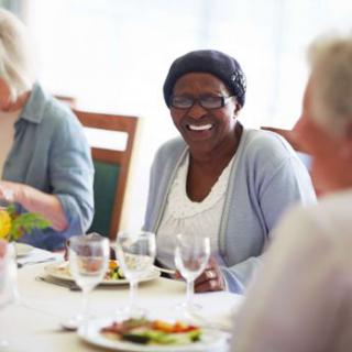 A group of people enjoying a meal together and socializing.