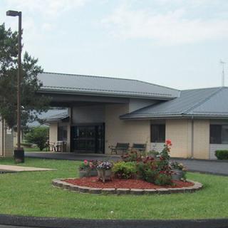 A modern building with a landscaped front garden.