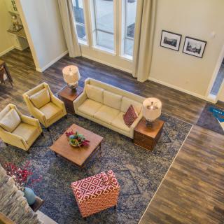 A spacious living room with comfortable seating and elegant decor.