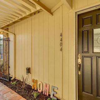 A welcoming front entrance with a home decor sign and house number.