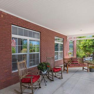 A cozy porch with rocking chairs and plants.
