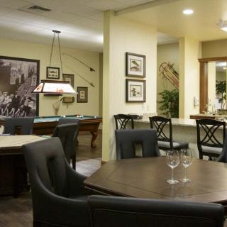 A cozy dining and recreation area featuring a pool table and elegant furnishings.