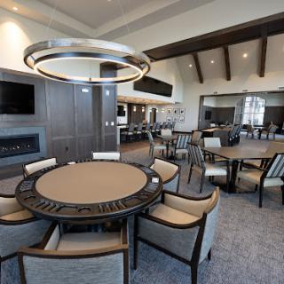 A modern dining room featuring stylish furniture and contemporary lighting.