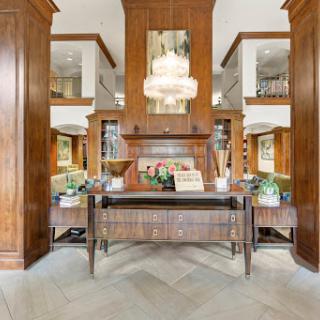 A beautifully designed entryway featuring elegant wood paneling and stylish furnishings.