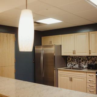 A modern kitchen with sleek cabinetry and contemporary lighting.