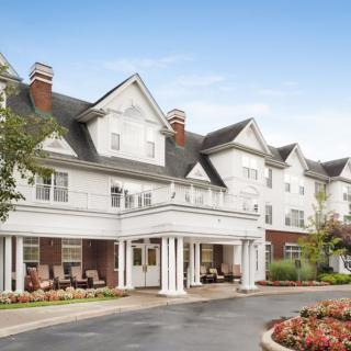 A large residential building with classic architecture and landscaped surroundings.