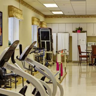 An indoor fitness center with various exercise equipment and treadmills.