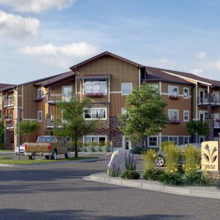 A modern residential apartment building surrounded by well-maintained landscaping.