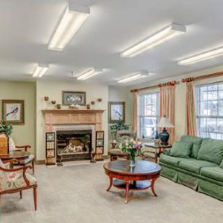 A cozy living room with comfortable seating and a fireplace.