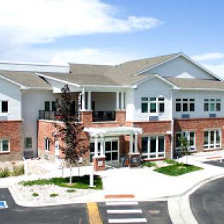 A modern community center with a welcoming entrance on a clear, sunny day.
