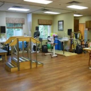 A rehabilitation room equipped with exercise and therapy equipment.
