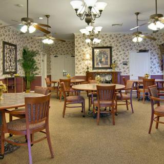 A cozy dining area with wooden furniture and elegant chandeliers.