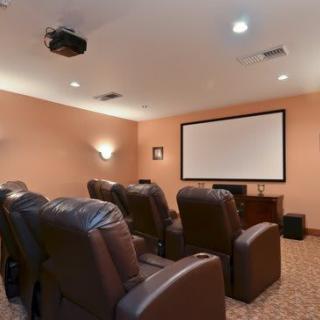 A cozy home theater setup with a projector and comfortable seating.