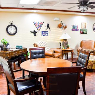 A cozy lounge area with comfortable seating and decorative wall art.
