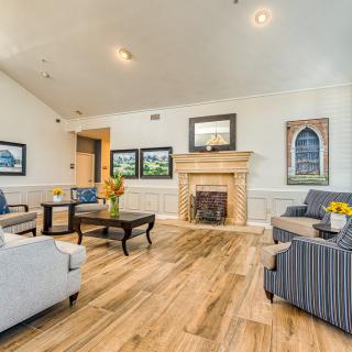A cozy and modern living room with a fireplace and elegant decor.
