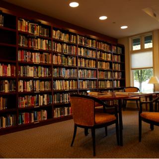A cozy library with bookshelves and a reading area.