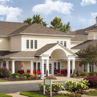 A large residential building with a landscaped garden and an inviting entrance.