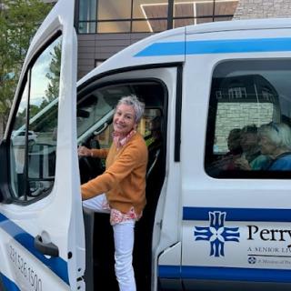 A cheerful individual getting into a van.
