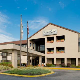 Exterior view of a hotel with flags and a welcoming entrance.