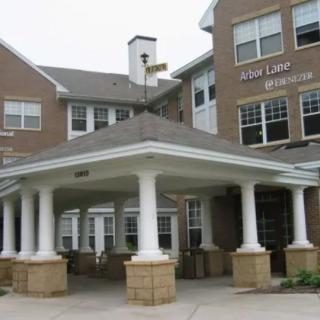 A residential building with a covered entrance supported by columns.