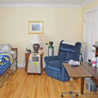 A bedroom with a hospital bed and medical equipment.