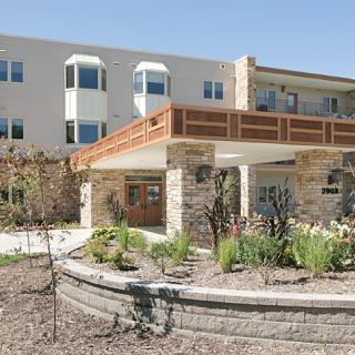 A modern residential building with landscaped surroundings.