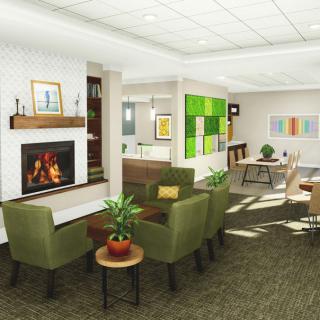 A modern and cozy lounge area with green chairs, a fireplace, and colorful artwork adorning the walls.