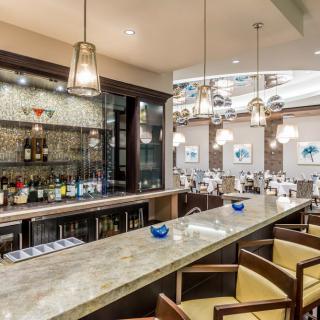 A modern bar and restaurant interior with stylish lighting and seating.