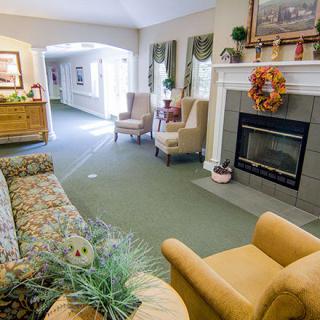 A cozy living room with a fireplace and comfortable seating.