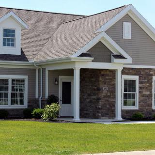 A suburban residential house with a well-maintained lawn.