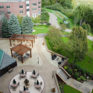 Aerial view of an outdoor patio area surrounded by lush greenery and walking paths.