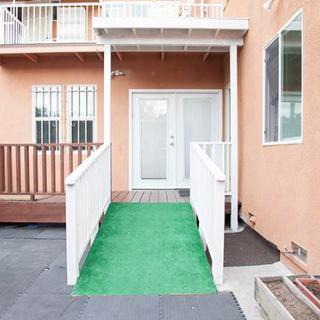 A wheelchair-accessible ramp leading to the entrance of a building.