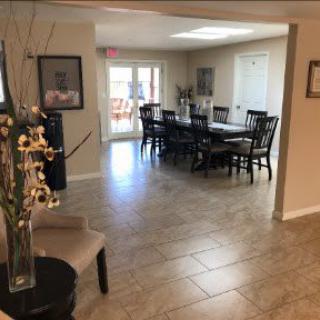 A cozy dining room with a large table and chairs, adorned with elegant decor.