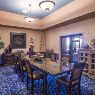 Elegant dining room with a large table and stylish decor.