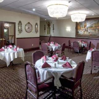 A beautifully arranged dining room featuring elegant tables and chandeliers, perfect for a sophisticated dining experience.