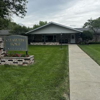 A residential building with a well-maintained lawn and clear pathway.