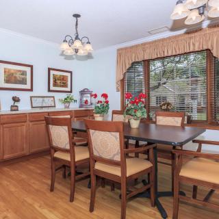 A cozy dining room with wooden furniture and decorative elements.