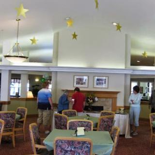 A cozy community lounge with people interacting and festive star decorations.