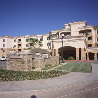 A luxurious hotel resort with a grand entrance and manicured landscaping.