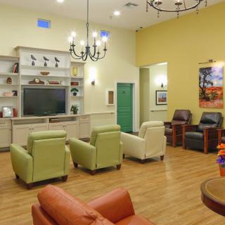 A cozy living room with comfortable seating and a large television.