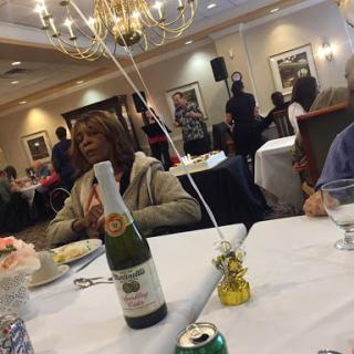 A cozy dining experience at a celebration with champagne and decorations.